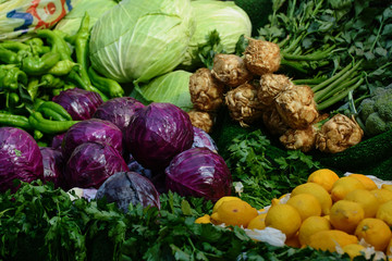 Lemon, parsley, celery, cabbage are spread out on the trading counter of the Turkish bazaar. The concept is healthy eating.