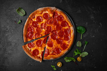 salami pizza. pepperoni pizza on black background