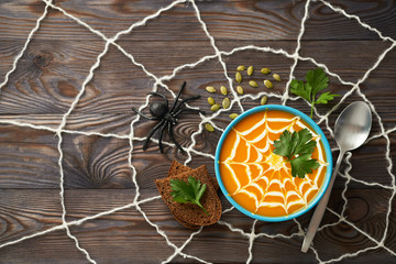 A healthy pumpkin puree garnished with cream and parsley leaves. Composition autumn cream soup with...