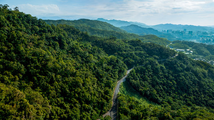 Mountain road through forest in Taiwan. Beautiful elevated view of an empty way.
