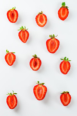 Strawberries pieces on a white background. Flat lay, vertical orientation.