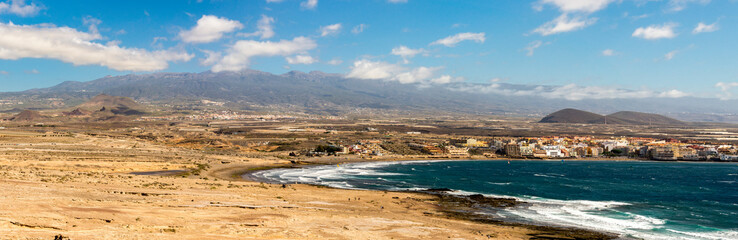A panoramic view of Playa Leocadio Machado beach and El Medano town from Mount Roja nature reserve, Tenerife, Spain © anastasstyles