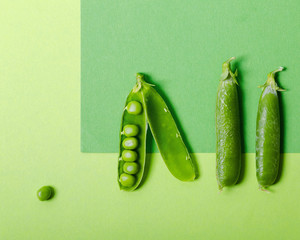 Green peas on green geometric background