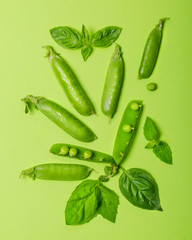 Green peas with mint and basil on green background