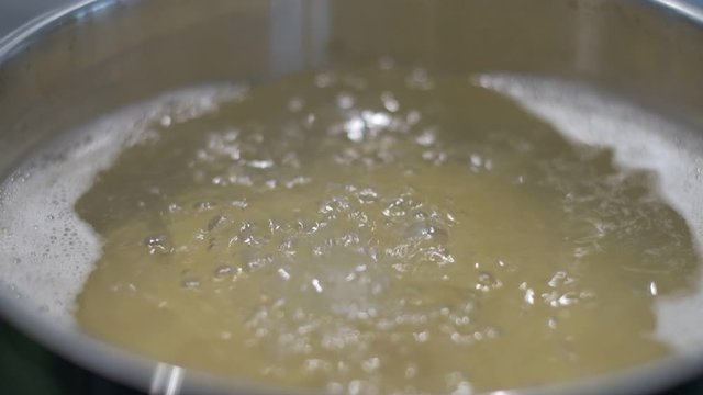 boiling water hot pot cooking kitchen high resolution slow motion close up bubbles 