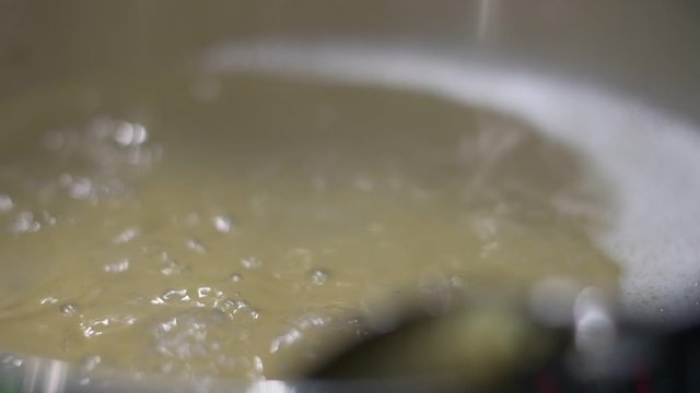 boiling water hot pot cooking kitchen high resolution slow motion close up bubbles 