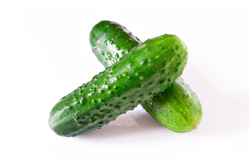 Set of wet fresh green cucumbers on a white isolated background.