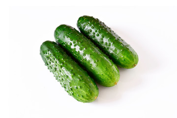Set of wet fresh green cucumbers on a white isolated background.