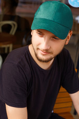 Handsome guy in green cap and shirt