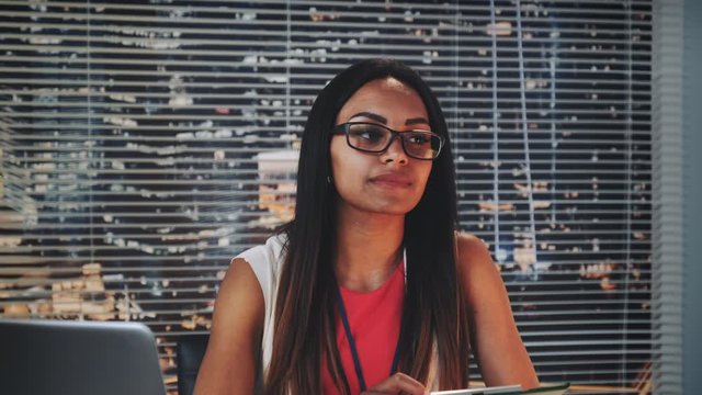 Close-up of african american family counselor smiling and happily looking at couple. She is satisfied with terapy result