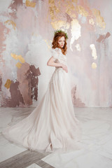 Fototapeta premium Elegant red-haired girl bride. Young beautiful woman in wedding dress