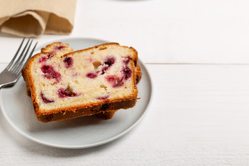 Homemade berry cake on white wooden background