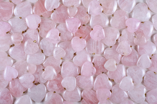 Bulk of rose quartz heart-shaped stones texture background