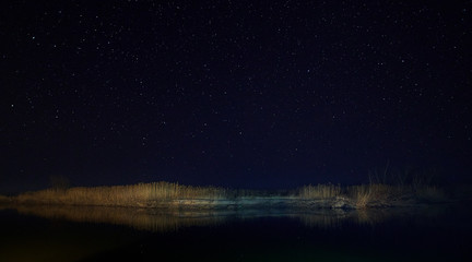 Stars in the sky above one of branches of Volga river, Russia, Astrakhan