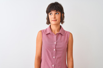 Young beautiful woman wearing red summer shirt standing over isolated white background smiling looking to the side and staring away thinking.