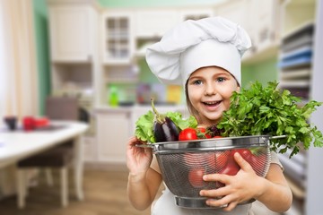 Portrait of adorable little girl preparing healthy food at kitchen