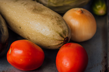 Vegetables, onions, eggplant, tomatoes and cucumbers in a basket. The concept of agriculture, healthy lifestyle, healthy eating and diet.