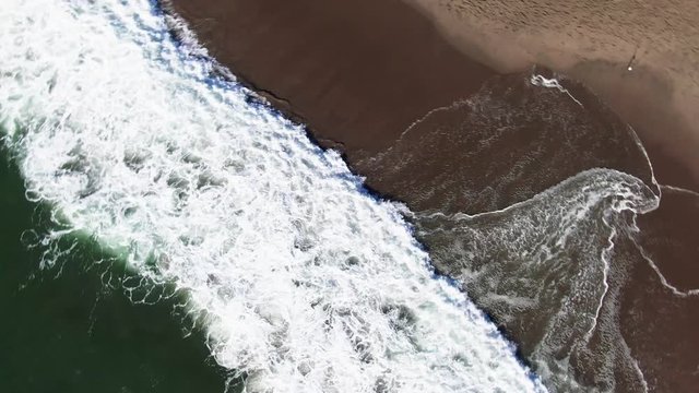 4K Close up Drone Flight Footage Aerial View Of Waves Crashing . Camera turns in a circle.