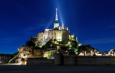 Mont Saint Michel at night, an UNESCO world heritage site in France. Abbey, panoramic view. Normandy, Northern France, Europe. 