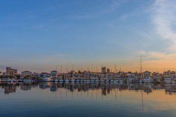 Fototapeta premium Port of Aegina town with yachts and fishermen boats docked in Aegina island, Saronic gulf, Greece, at sunrise.
