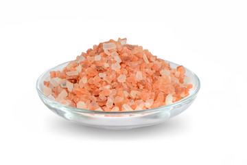 Fototapeta na wymiar Heap of pink himalayan salt in a glass saucer isolated on white background. Himalayan salt is used in cooking, medicine and cosmetology.
