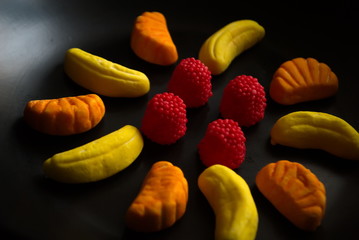 Fruit candy on black. Delicious fruit candy. Multicolored fruit candy. - 282928006