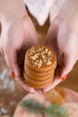 Homemade fragrant gingerbread cookies in female hands with a beautiful manicure