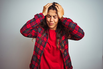 Young beautiful woman wearing red t-shirt and jacket standing over white isolated background suffering from headache desperate and stressed because pain and migraine. Hands on head.