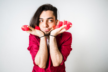 Young magician performing some funny tricks by gesturing with his face.