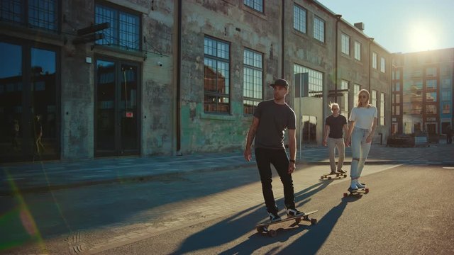
Group of Girls and Boys on Skateboards Through Fashionable Hipster District. Beautiful Young People Skateboarding Through Modern Stylish City Street. Moving Slow Motion Portrait Camera Shot 