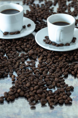 black coffee in small cups.  spilled whole grains