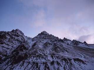 Fototapeta premium mountains in winter with snow and a pink sky in Iceland