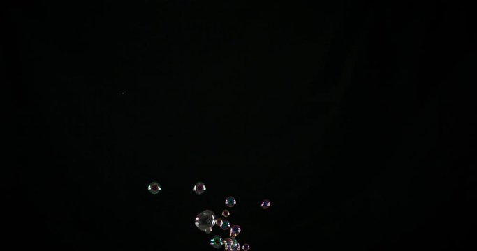 Rainbow soap bubbles on black background