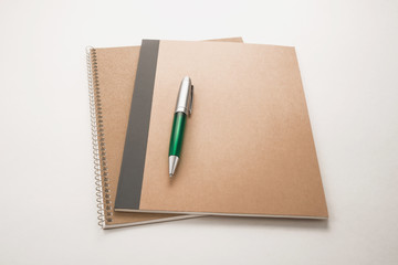  Notebooks and pen on white background
