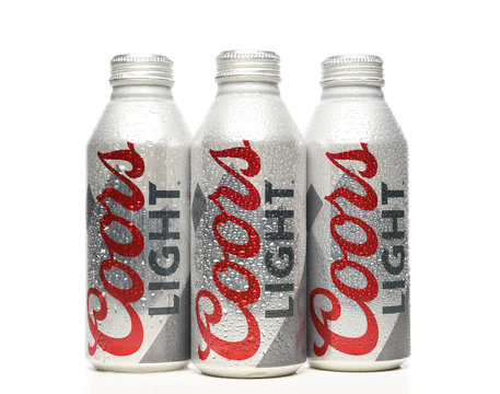 IRVINE, CALIFORNIA - APRIL 15, 22019: Three Coors Light Aluminum Pint Bottles with condensation on white with reflection.