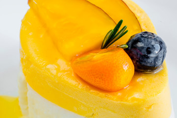 Passion fruit cake, mousse dessert on a white plate. macro.