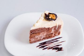 Delicious chocolate cake on plate on table on light background