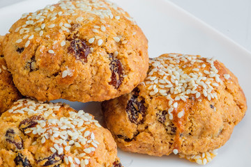 Closeup macro photo of a stack of freshly baked home made chewy Oatmeal cookies with raisin isolated on white background