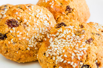 Homemade oatmeal cookies on white wooden table.