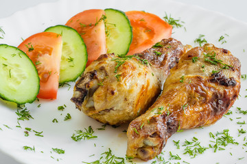 Dinner background. Grilled chicken drumsticks with rosemary.