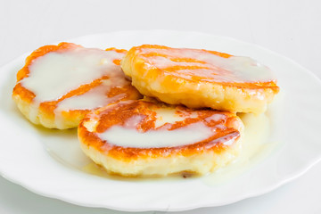 Homemade cottage cheese pancakes with banana, condensed milk and fresh mint, white background, breakfast,top view