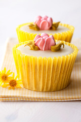 Yellow flower cupcakes with fresh flowers