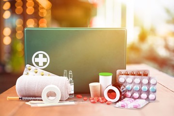 First aid kit  with medical supplies on light background