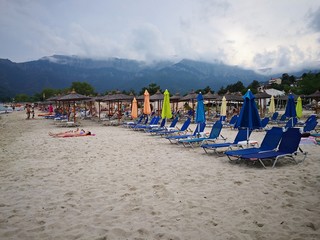 Fototapeta na wymiar Chairs and umbrella on the beach