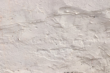 Obraz premium Old stone wall with cracks, natural concrete background, old natural texture of an ancient stone. It is used for decoration of buildings and embankments, a wonderful background for the desktop