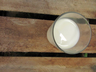 Glass of milk on wooden table
