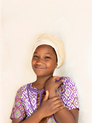 Portrait of a shy little girl wearing an embroidered dress and a traditional headscarf (eleven years old child)