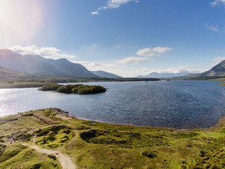 Nature landscape, Connemara national park, Ireland, Lakes with blue water, mountains in the background. Aerial view, Cloudy sky.