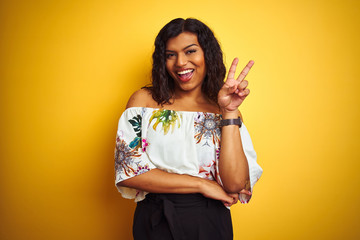 Transsexual transgender woman wearing summer t-shirt over isolated yellow background smiling with...