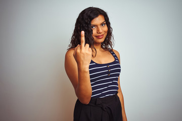 Transsexual transgender woman wearing striped t-shirt over isolated white background Showing middle finger, impolite and rude fuck off expression